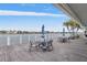 Waterfront deck with tables, umbrellas, and seating at 9415 Blind Pass Rd # 905, St Pete Beach, FL 33706