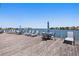Relaxing waterfront deck with lounge chairs and tables at 9415 Blind Pass Rd # 905, St Pete Beach, FL 33706