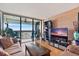 Spacious living room with water view, comfy seating, and a large TV at 9415 Blind Pass Rd # 905, St Pete Beach, FL 33706