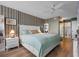 Main bedroom with king-size bed, ensuite bathroom access, and built-in drawers at 9415 Blind Pass Rd # 905, St Pete Beach, FL 33706