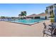 Community pool with lounge chairs and patio furniture at 9415 Blind Pass Rd # 905, St Pete Beach, FL 33706