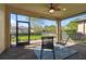 Screened porch with ceiling fan and view of backyard at 12926 Payton St, Odessa, FL 33556