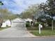 House exterior featuring a two-car garage and front yard at 13112 Royal George Ave, Odessa, FL 33556