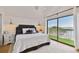 Main bedroom with water views, king bed, and private balcony access at 15421 2Nd E St, Madeira Beach, FL 33708