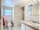 Clean bathroom with a large vanity, shower, and linen closet at 2331 Belleair Rd # 116, Clearwater, FL 33764