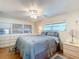 Main bedroom with a ceiling fan, dresser, and built in cabinets at 2331 Belleair Rd # 116, Clearwater, FL 33764