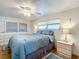 Spacious bedroom with a ceiling fan, dresser, and large windows at 2331 Belleair Rd # 116, Clearwater, FL 33764