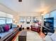Living room with leather furniture, hardwood floors, and access to porch at 2331 Belleair Rd # 116, Clearwater, FL 33764