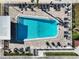 Community pool with numerous lounge chairs and surrounding landscaping at 2331 Belleair Rd # 116, Clearwater, FL 33764
