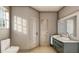 Modern bathroom with a walk-in shower, double vanity, and green cabinets at 2713 San Luis Rd, Holiday, FL 34691