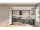 Modern kitchen with two-tone cabinets, an island with seating, and stainless steel appliances at 2713 San Luis Rd, Holiday, FL 34691