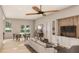 Open-concept living room and dining area with wood floors and large windows at 2713 San Luis Rd, Holiday, FL 34691