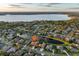 Aerial view of house and neighborhood by the lake at 3921 Mimosa Pl, Palm Harbor, FL 34685