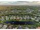 Wide aerial view of the neighborhood and lake at 3921 Mimosa Pl, Palm Harbor, FL 34685