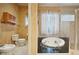 Bathroom with toilet, bidet, and a corner bathtub at 3921 Mimosa Pl, Palm Harbor, FL 34685