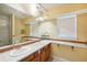 Bathroom with double vanity and a large mirror at 3921 Mimosa Pl, Palm Harbor, FL 34685