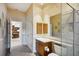 Elegant bathroom with a glass shower, double vanity, and view to kitchen at 3921 Mimosa Pl, Palm Harbor, FL 34685