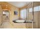 Large bathroom with a jetted tub, walk-in shower, and double sinks at 3921 Mimosa Pl, Palm Harbor, FL 34685
