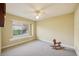 Bright bedroom with window seat and ceiling fan at 3921 Mimosa Pl, Palm Harbor, FL 34685
