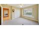 Spacious bedroom with double doors and window seat at 3921 Mimosa Pl, Palm Harbor, FL 34685
