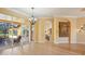 Spacious dining room with hardwood floors, chandelier, and kitchen access at 3921 Mimosa Pl, Palm Harbor, FL 34685