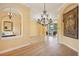 Open dining room with hardwood floors, chandelier, and pool view at 3921 Mimosa Pl, Palm Harbor, FL 34685