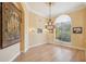 Elegant dining room with hardwood floors, chandelier, and tapestry at 3921 Mimosa Pl, Palm Harbor, FL 34685