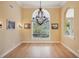 Elegant dining room featuring hardwood floors, large window, and chandelier at 3921 Mimosa Pl, Palm Harbor, FL 34685