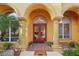 Elegant entryway with arched details, double doors, and welcoming ambiance at 3921 Mimosa Pl, Palm Harbor, FL 34685