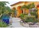 Landscaped entryway with tropical plants, stonework, and a water feature at 3921 Mimosa Pl, Palm Harbor, FL 34685
