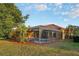 House back view features a screened pool and patio area at 3921 Mimosa Pl, Palm Harbor, FL 34685