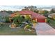 Luxury house with a red tile roof and palm trees at 3921 Mimosa Pl, Palm Harbor, FL 34685