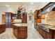 Large kitchen with granite counters, custom cabinetry and breakfast bar at 3921 Mimosa Pl, Palm Harbor, FL 34685