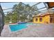 Inviting screened pool with tiled spa and lake view at 3921 Mimosa Pl, Palm Harbor, FL 34685