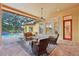 Covered patio with wicker furniture and access to the pool and house at 3921 Mimosa Pl, Palm Harbor, FL 34685