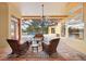 Relaxing covered patio with wicker furniture, overlooking the pool at 3921 Mimosa Pl, Palm Harbor, FL 34685