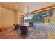 Covered patio with wicker furniture and access to the pool and house at 3921 Mimosa Pl, Palm Harbor, FL 34685