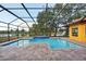 Inviting screened pool with tiled spa and lake view at 3921 Mimosa Pl, Palm Harbor, FL 34685