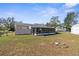 View of backyard, screened porch and shed at 5592 Fairway Dr, Ridge Manor, FL 33523
