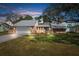 Brick house with a two-car garage, and a well-maintained lawn at 5592 Fairway Dr, Ridge Manor, FL 33523