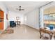 Sunlit Gathering room with tile flooring and access to screened porch at 5592 Fairway Dr, Ridge Manor, FL 33523