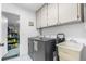 Bright laundry room with washer, dryer, and utility sink at 5592 Fairway Dr, Ridge Manor, FL 33523