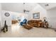 Spacious living room with a comfortable sofa and large TV at 5592 Fairway Dr, Ridge Manor, FL 33523