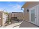 Small patio area with a bench and surrounded by a wooden fence at 5592 Fairway Dr, Ridge Manor, FL 33523