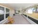 Relaxing screened porch with wooden chairs at 5592 Fairway Dr, Ridge Manor, FL 33523