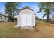 Large storage shed with double doors and wooden ramp at 5592 Fairway Dr, Ridge Manor, FL 33523