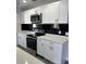 Modern kitchen with white shaker cabinets and quartz countertops at 7222 Riverwood Blvd, Tampa, FL 33615