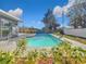 Relaxing pool area with lush landscaping and a spacious patio at 908 Normandy Rd, Clearwater, FL 33764