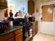 Kitchen with wood cabinets, stove, and refrigerator at 2302 Maki Rd # 5, Plant City, FL 33563