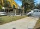 Single-wide manufactured home with detached garage and fenced yard at 10040 Jungle St, New Port Richey, FL 34654